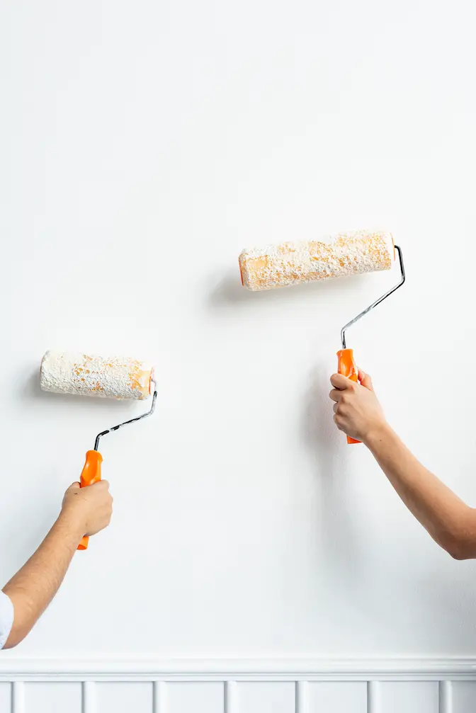 two-hands-painting-wall